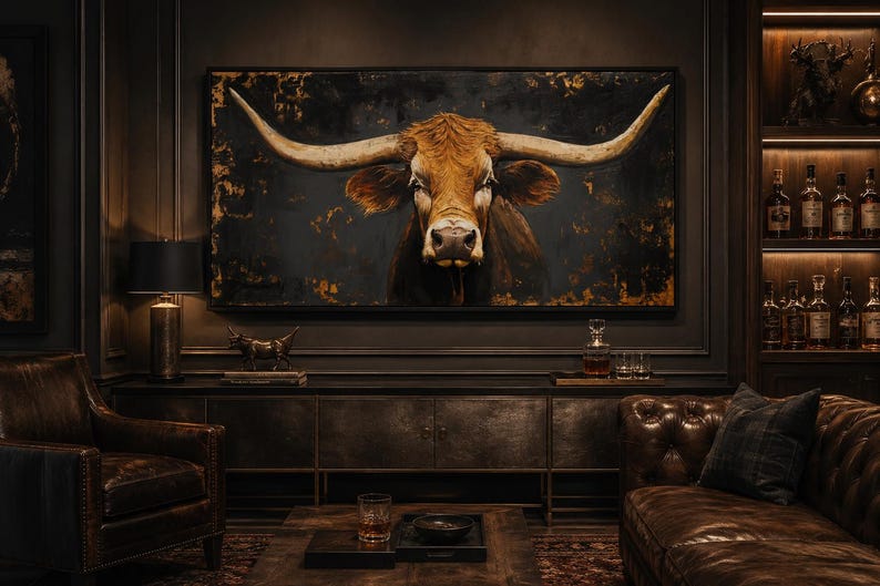 May include: A large rectangular wall art piece featuring a detailed portrait of a brown longhorn steer with expansive horns against a dark, textured background with gold accents, displayed in a dimly lit room with dark wood furniture.
