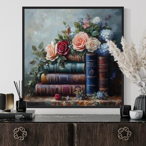 a painting of a bouquet of flowers on top of a stack of books, displayed on a wooden dresser.