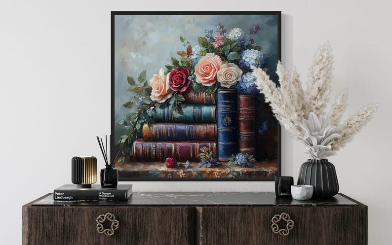 a painting of a bouquet of flowers on top of a stack of books, displayed on a wooden dresser.