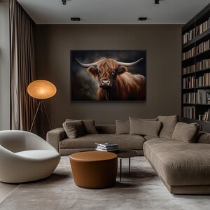 a modern living room with a large window overlooking trees, a comfortable sofa, a round coffee table, and a large painting of a horned animal on the wall.