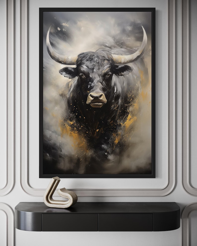 a large black bull with prominent horns, which is the central focus of the artwork displayed on the wall.
