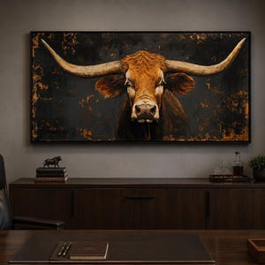 May include: A rectangular wall art piece featuring a detailed portrait of a brown longhorn bull with large, sweeping horns. The bull is set against a dark, textured background with distressed gold and bronze accents, framed in a thin black border.