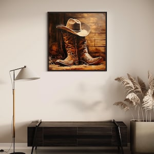 a framed painting of a pair of cowboy boots hanging on a wall above a wooden bench.