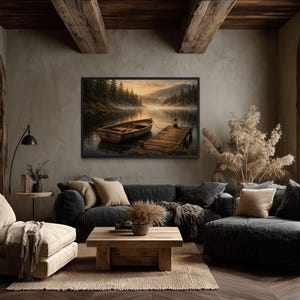 May include: A cozy living room with a framed landscape painting of a lake and boat. The room features a dark gray sofa, a wooden coffee table, and a beige armchair. The room is decorated with neutral tones and natural elements.