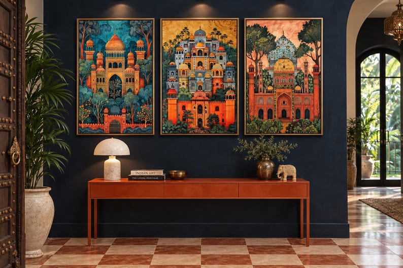 May include: Three framed rectangular wall art prints featuring intricate architectural structures with domes and arches in vibrant orange, blue, and gold tones, displayed above a long, narrow, orange wooden console table with books and decor.
