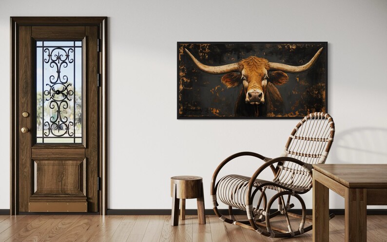 a rustic interior with a wooden door, a large framed picture of a bull's head hanging on the wall, a wicker chair, and a wooden stool.
