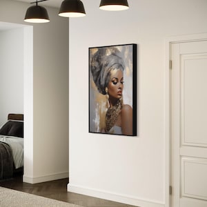 a modern art piece depicting a woman with a headdress, hanging on a white wall in a room with a wooden floor.
