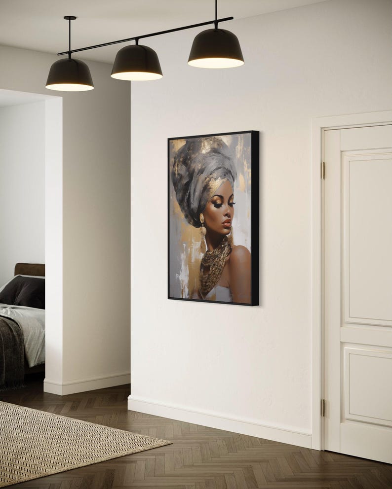 a modern art piece depicting a woman with a headdress, hanging on a white wall in a room with a wooden floor.