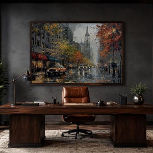 May include: A rectangular framed oil painting depicting a rainy New York City street scene with a yellow taxi, autumn trees, and the Empire State Building in the background, mounted on a dark gray wall above a large wooden executive desk.