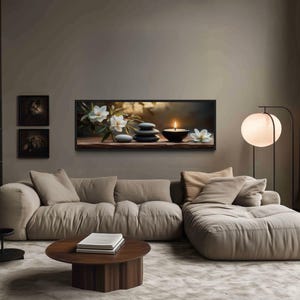 a cozy living room with a large bookshelf filled with books, a comfortable sofa, a coffee table, and a painting of flowers on the wall.