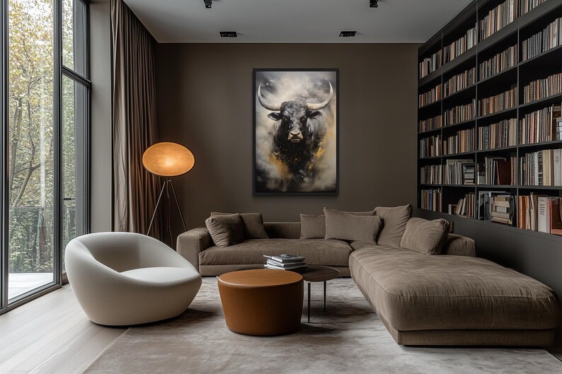a modern living room with a large window overlooking trees, a white sofa, a round coffee table, and a large painting of a bull on the wall.