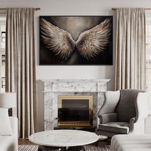 a luxurious living room with a large painting of a pair of angelic wings hanging above a fireplace. The room is furnished with a gray armchair, a white sofa, and a round marble coffee table. The overall decor and furnishings create a sophisticated and elegant atmosphere.