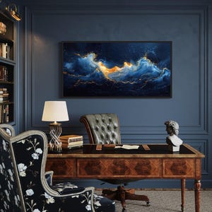 a well-decorated office space with a large abstract painting of a swirling ocean scene on the wall, complemented by a wooden desk, a tufted leather chair, and a lamp.