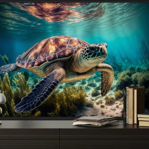 a large framed picture of a sea turtle swimming in the ocean, with a coral reef and underwater plants visible in the background.