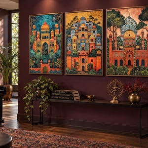 May include: Three rectangular framed wall art prints featuring vibrant, detailed illustrations of ornate palaces with domes, arches, and lush greenery. The artwork displays a rich colour palette of deep oranges, blues, and greens, presented in thin gold frames.