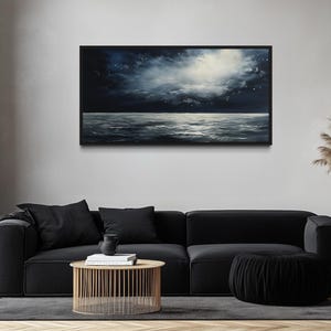 a modern living room with a black sofa, a wooden coffee table, and a large painting of a stormy ocean scene hanging on the wall above the sofa.