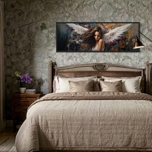May include: A bedroom scene with a bed covered in a beige duvet and pillows. Above the bed is a framed artwork of a woman with angel wings. The room has a neutral colour scheme with patterned wallpaper and wooden furniture.