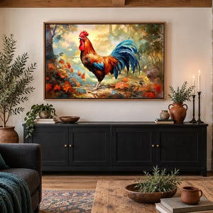 May include: A rectangular wall art print featuring a vibrant rooster with red, orange, and blue plumage standing in a forest setting with autumn leaves. The artwork is enclosed in a thin wooden frame and displayed above a black media console cabinet.