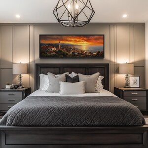 a modern bedroom with a large bed, dark wood furniture, and a painting of a sunset on the wall above it.