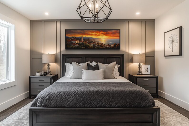 a modern bedroom with a large bed, dark wood furniture, and a painting of a sunset on the wall above it.