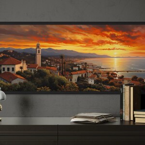 a large painting of a picturesque coastal town at sunset, with a warm orange and red sky and silhouetted mountains in the background.