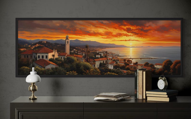 a large painting of a picturesque coastal town at sunset, with a warm orange and red sky and silhouetted mountains in the background.