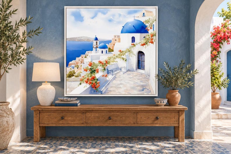 May include: A square framed wall art print depicting a Mediterranean coastal scene with white buildings, bright blue domes, and vibrant orange flowers. The painting features a stone pathway leading toward the sea under a clear blue sky.