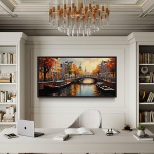 a modern office space with a large painting of a cityscape hanging on the wall, a chandelier, a desk with a laptop, and a bookshelf filled with books.