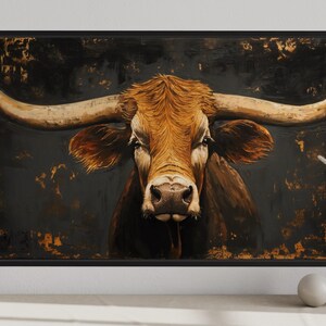 a large painting of a bull with long horns, displayed on a wall.