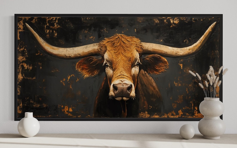 a large painting of a bull with long horns, displayed on a wall.