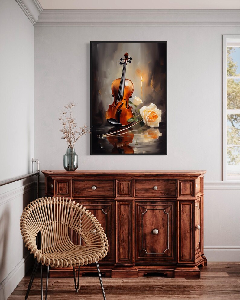 a framed painting of a violin and a rose on a wooden cabinet, with a woven chair in the foreground.
