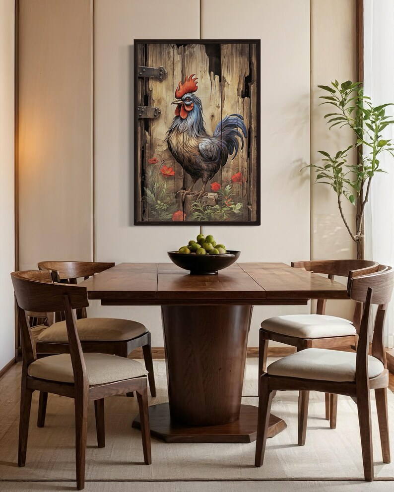 a wooden dining table with a bowl of fruit on it, surrounded by wooden chairs. Above the table, there is a framed painting of a rooster on a wooden door.