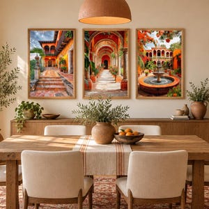 May include: Three framed wall art prints depicting architectural scenes of a Spanish colonial courtyard, a stone arched walkway, and a central fountain, displayed in a dining room with a wooden table, chairs, and a sideboard.