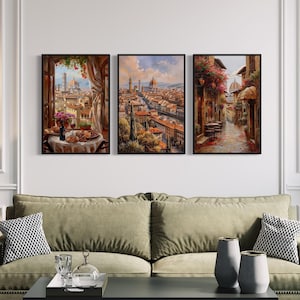 a modern living room with a green sofa, a coffee table, and three framed paintings hanging on the wall above it.