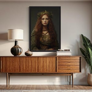a wooden cabinet with a lamp and a framed portrait of a woman with long red hair, which is hanging on the wall above the cabinet.