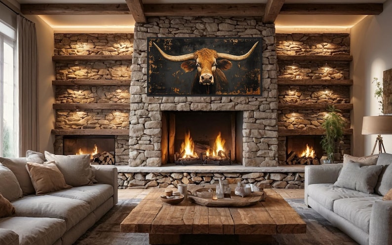 a cozy living room with a stone fireplace, a wooden coffee table, and two couches. Above the fireplace, there is a large framed picture of a bull's head.