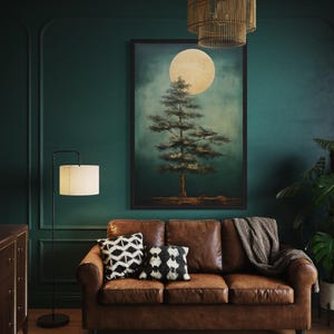a cozy living room with a brown leather sofa, a wooden floor lamp, and a large painting of a tree on the wall.