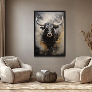a living room with a large painting of a bull's head hanging on the wall. The bull has a black and white color scheme, and its horns are prominently displayed. The room is furnished with two beige armchairs and a round coffee table, creating a comfortable and inviting atmosphere.
