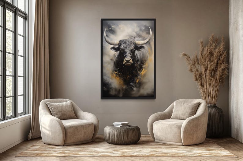 a living room with a large painting of a bull's head hanging on the wall. The bull has a black and white color scheme, and its horns are prominently displayed. The room is furnished with two beige armchairs and a round coffee table, creating a comfortable and inviting atmosphere.
