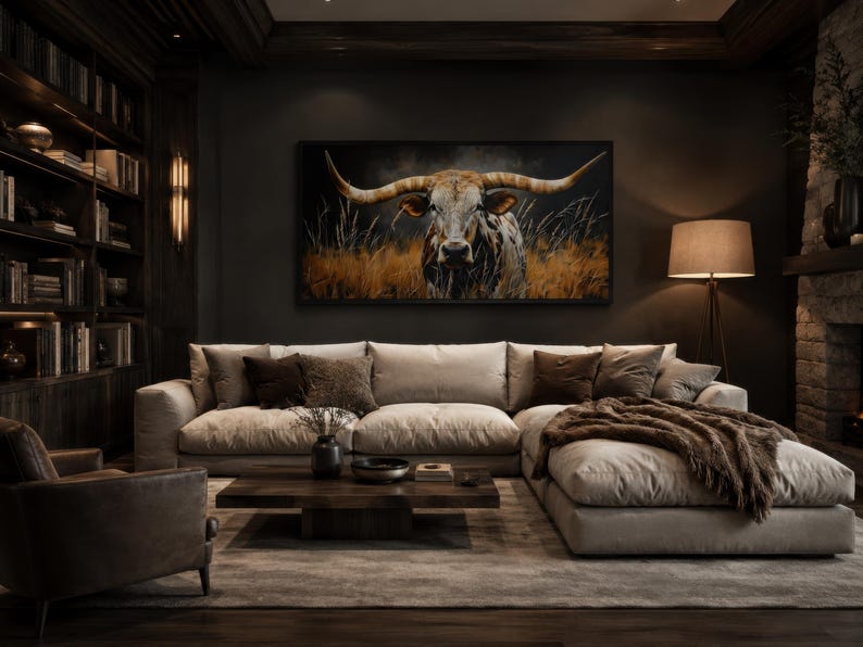 May include: A luxurious living room with a large beige sectional sofa, a dark wood coffee table, and a framed painting of a longhorn. The room features a bookshelf, a floor lamp, and a fireplace, creating a cozy and elegant atmosphere.