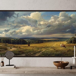 a large painting of a countryside landscape with a cow grazing in the foreground. The painting is hung on a wall above a wooden shelf, which has various items on it, including a mirror, a candle holder, and a bowl.