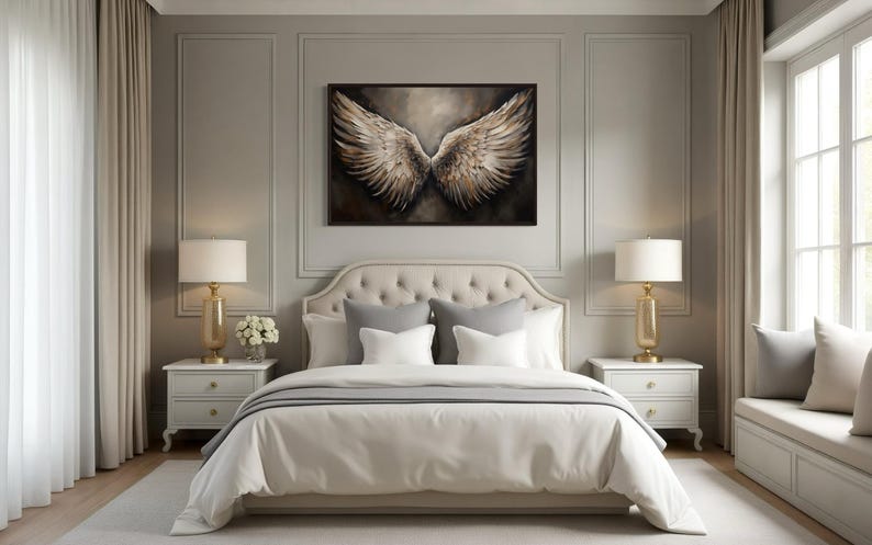 a luxurious bedroom with a large bed, white bedding, and a framed artwork of a winged creature on the wall. The room has a neutral color scheme with white walls, a gray carpet, and white furniture, creating a serene and elegant atmosphere.