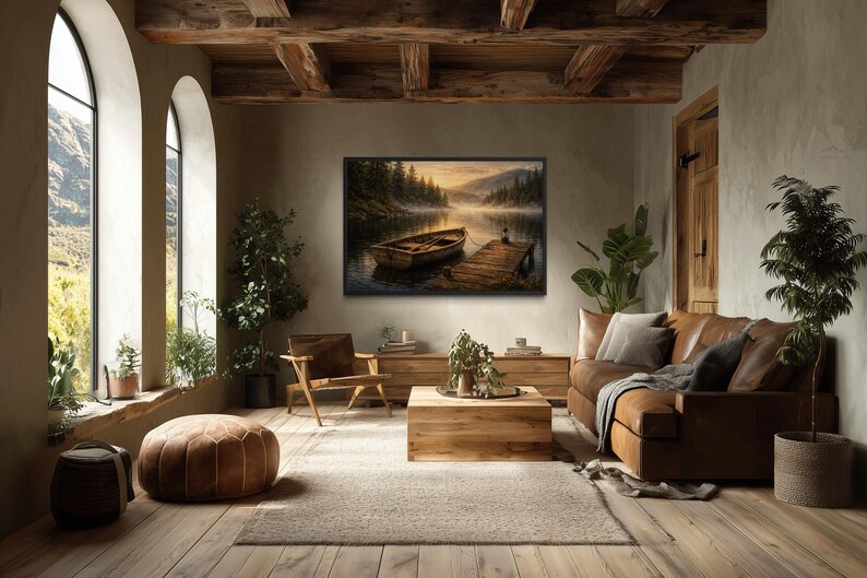 May include: A cozy living room with a large framed landscape painting of a boat on a lake. The room features a brown leather sofa, wooden furniture, and large arched windows. A brown ottoman and a neutral rug complete the scene.