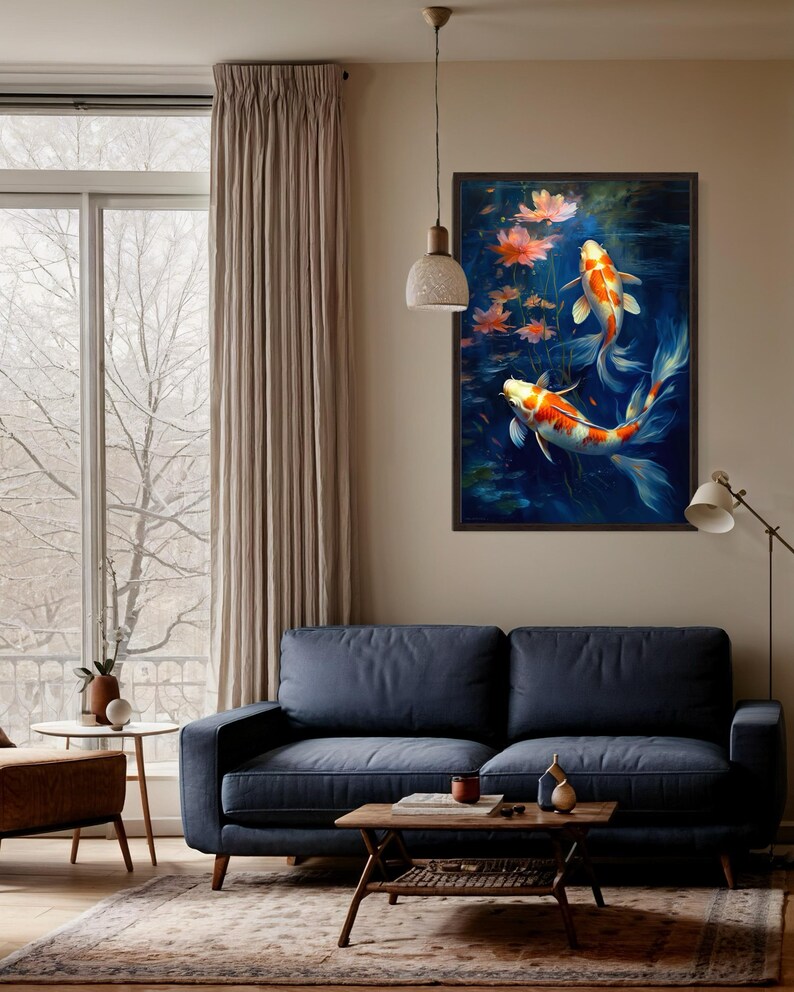 a serene living room with a blue sofa, a wooden coffee table, and a large window overlooking a snowy landscape. A framed painting of two koi fish swimming in a pond is hanging on the wall above the sofa.