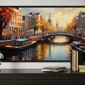 a large painting of a canal scene with boats and buildings, hanging on a wall above a wooden dresser.