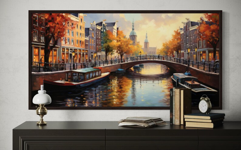 a large painting of a canal scene with boats and buildings, hanging on a wall above a wooden dresser.