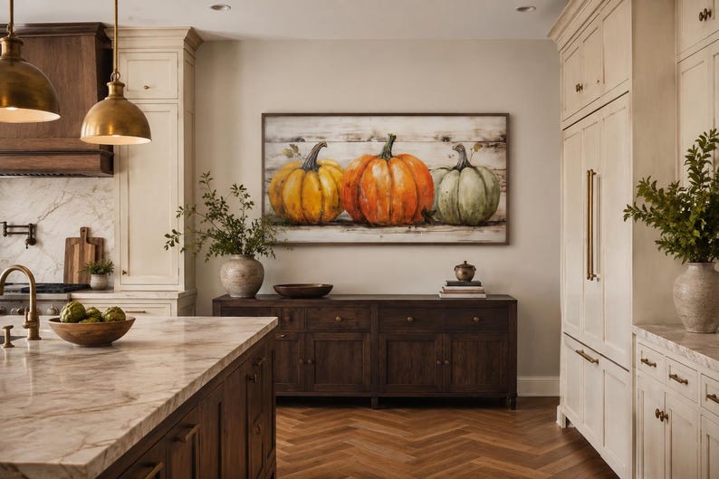 May include: A rectangular wall art piece featuring a painting of three pumpkins in yellow, orange, and green hues, set against a horizontal wood plank background. The artwork is framed in a dark wood border and displayed on a neutral-colored wall.