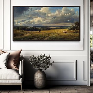 a large landscape painting hanging on a wall in a modern living room.