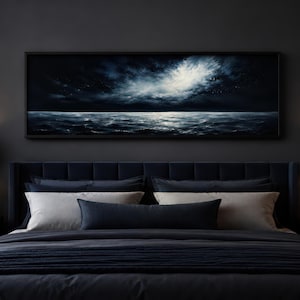 Peut inclure: Chambre sombre avec un lit bleu marine, des oreillers et de la literie. Une œuvre d'art encadrée représentant un paysage marin est accrochée au-dessus du lit. Deux lampes noires avec des accents dorés sont placées de chaque côté du lit.