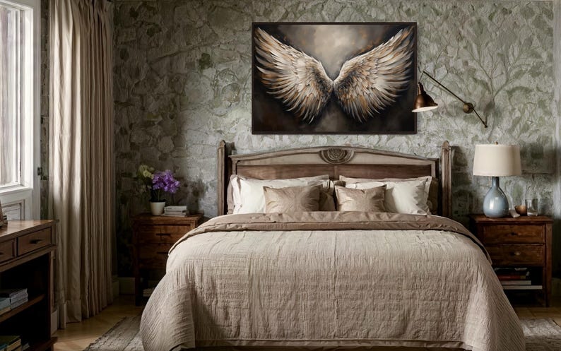 a bedroom with a large bed, a painting of large wings on the wall, and a window with curtains.